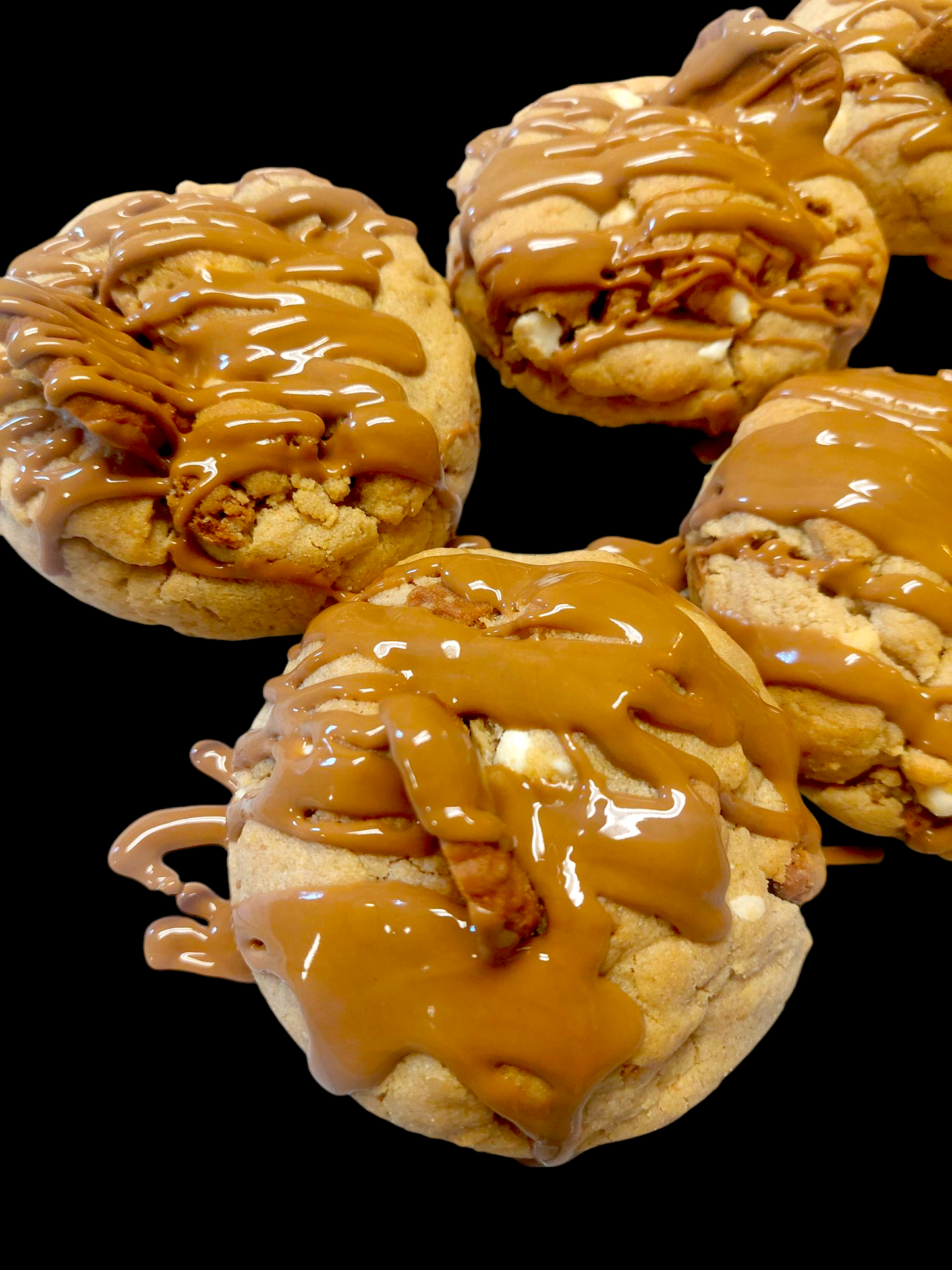 Close-up of Big Ass Biscoff cookies with cookie butter dough, Biscoff chunks, white chocolate chips and cookie butter drizzle